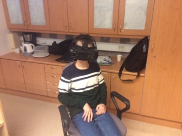 Lapsi istuu tuolilla VR-lasit päässä.